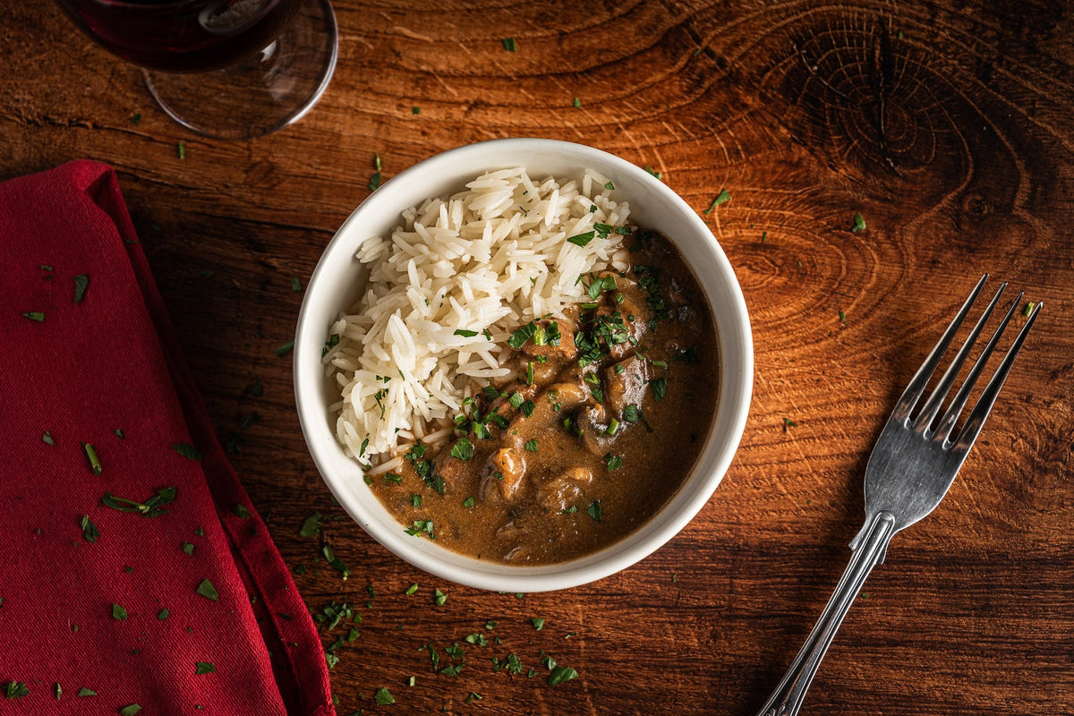 Our Beef Stroganoff features tender braising steak and mushrooms in a rich, creamy soured cream sauce, delicately seasoned with garlic, mustard and black pepper. Served with fluffy basmati rice, it's a comforting classic that's freshly prepared and cooked here in Torquay.